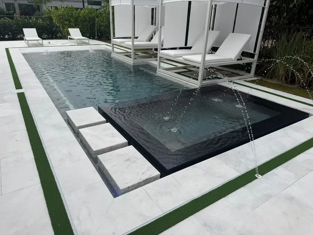 Santo Grande Residence 03 pool with raised spa, arcing water jets and covered poolside daybeds